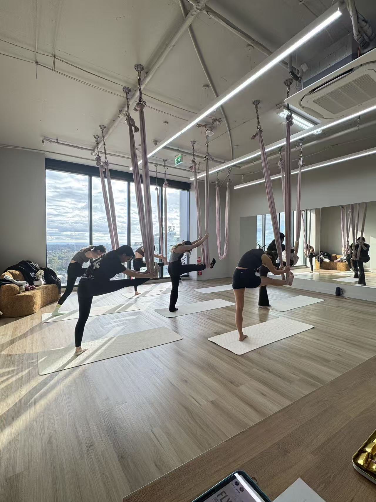 Aerial yoga practice at Skyra Studio