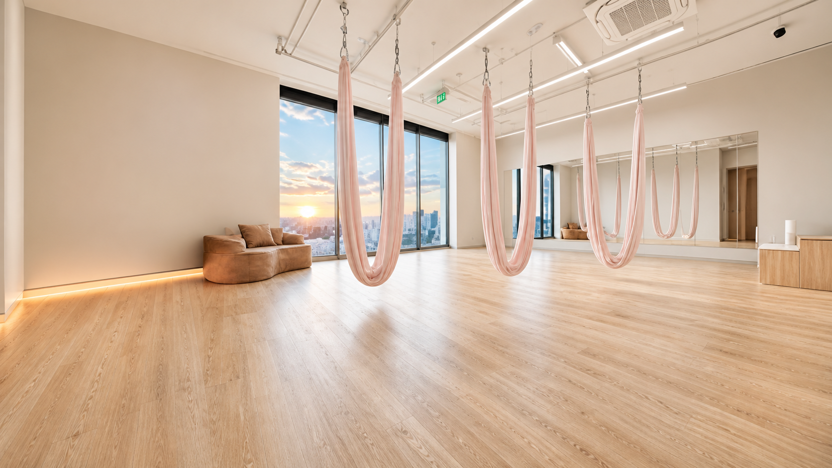 Skyra Studio aerial room with peach silks and sunset light