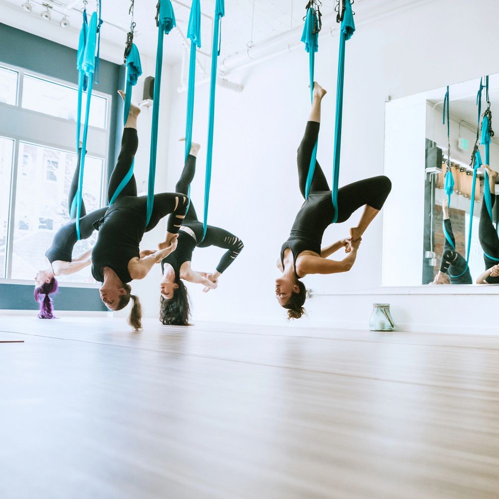 Aerial hammock class in a bright studio
